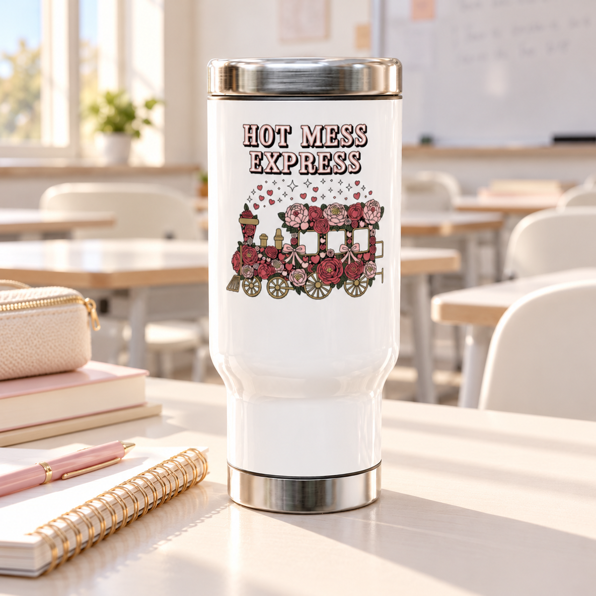 A white stainless steel travel mug with a silver lid and base, printed with "HOT MESS EXPRESS" in pink lettering above a steam train covered in pink and red roses and bows, with hearts and sparkles rising from it.