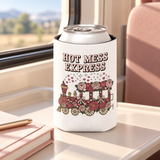 A white can cooler on a drink can, printed with "HOT MESS EXPRESS" in pink lettering above a steam train covered in pink and red roses and bows, with hearts and sparkles rising from it.