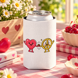 A white can cooler on a drink can, printed with a smiling cartoon red heart holding hands with a smiling yellow peace sign character, with small sparkles.