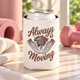A white can cooler on a drink can, printed with "Always Moving" in brown script around a bouquet of pink peonies between a pair of pink and white sneakers.