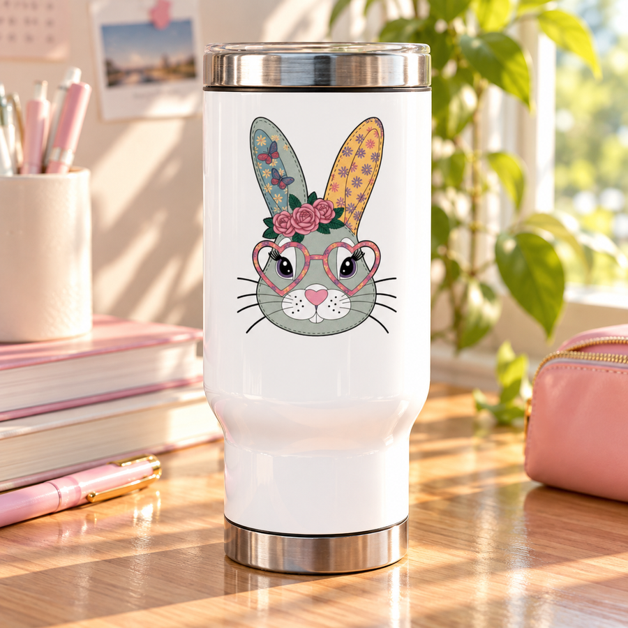 A white stainless steel travel mug with a silver lid and base, printed with a cute gray-green bunny face wearing pink heart-shaped glasses and a crown of pink roses, with butterfly and flower patterned ears.