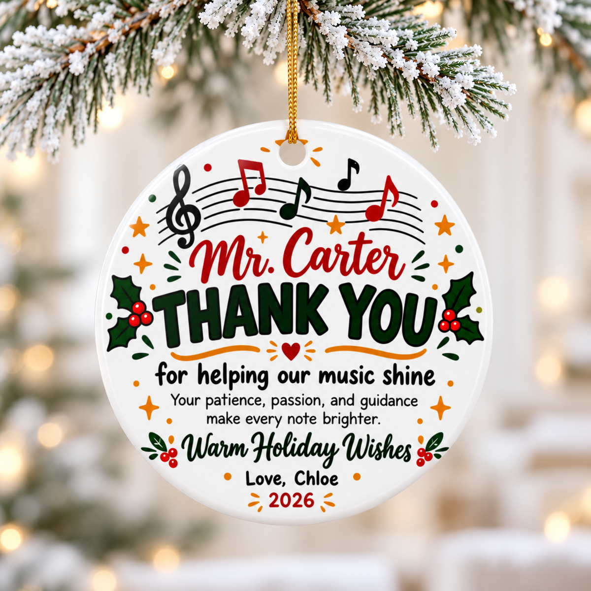 A round white ceramic Christmas ornament on a gold string, printed with a treble clef and red, green and black notes on a staff above a sample teacher name, "THANK YOU for helping our music shine", a short note of thanks, holly, "Warm Holiday Wishes" and a "Love" signature with "2026".