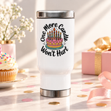 A white stainless steel travel mug with a silver lid and base, printed with "One More Candle Won't Hurt" in black script around a pink and yellow birthday cake with striped lit candles.