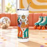 A white stainless steel skinny tumbler with a clear lid and metal straw, printed with a group of roller skaters in 70s flares dancing around a tiered birthday cake under a disco ball, in orange, teal, mustard and lavender.
