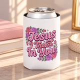 A white can cooler on a drink can, printed with "Jesus I Trust In You" in pink retro script framed by pink, red and purple roses and greenery.