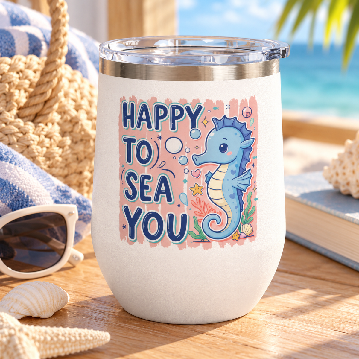 A white stainless steel stemless wine tumbler with a clear push-on lid, printed with "HAPPY TO SEA YOU" in navy lettering beside a smiling blue seahorse with bubbles, coral and a shell on a peach background.