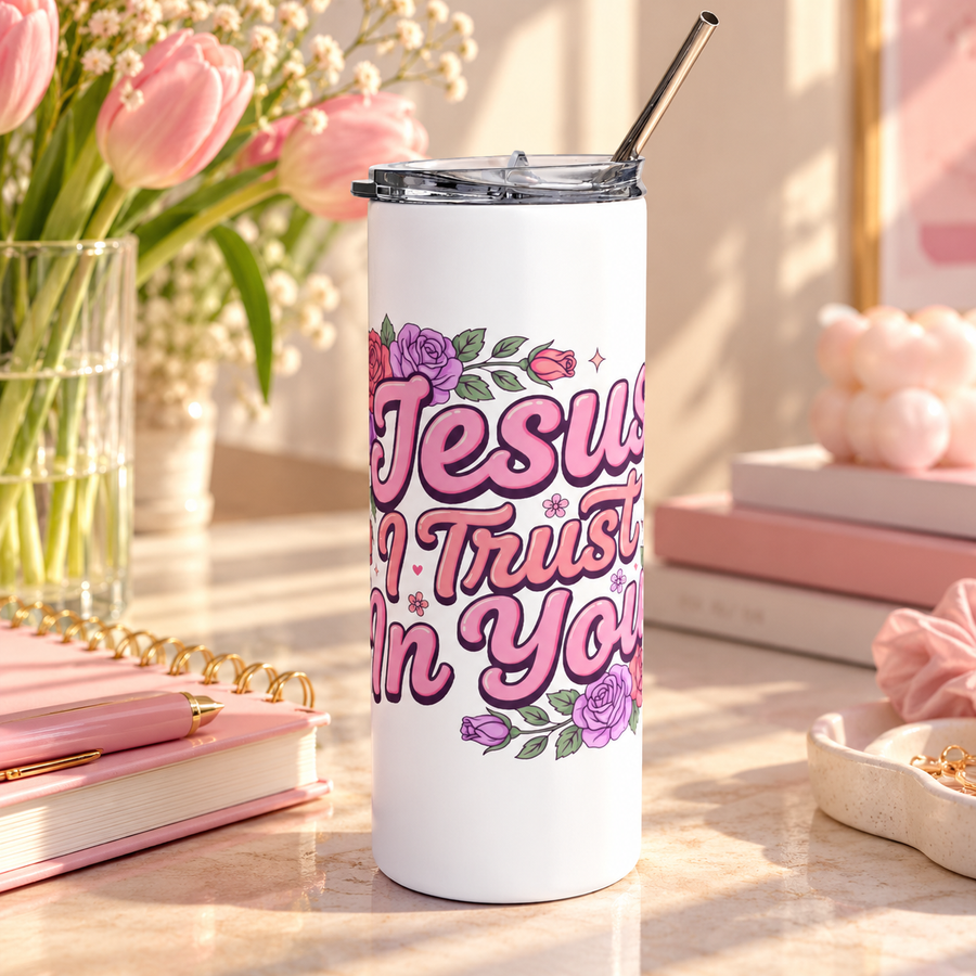 A white stainless steel skinny tumbler with a clear lid and metal straw, printed with "Jesus I Trust In You" in pink retro script framed by pink, red and purple roses and greenery.