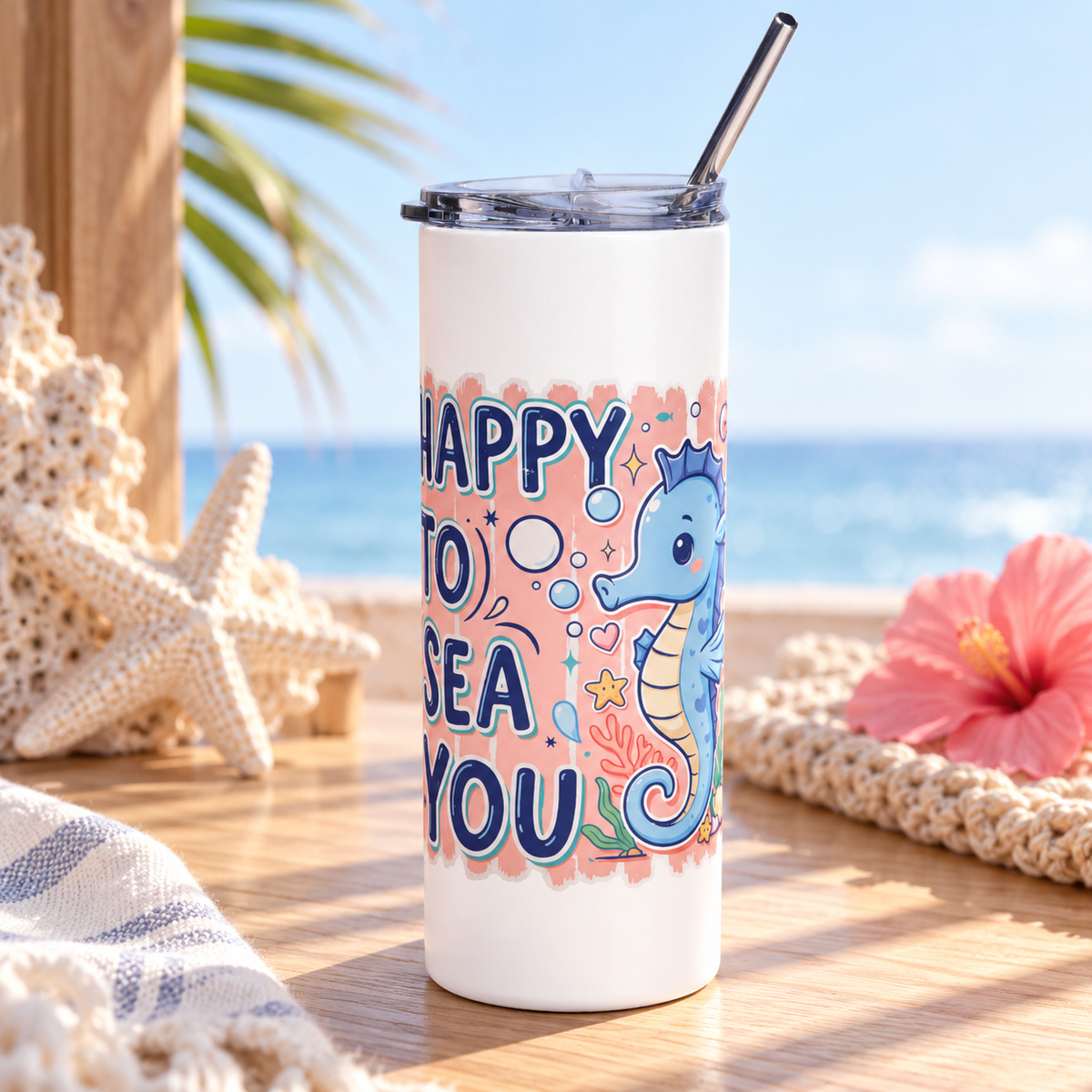 A white stainless steel skinny tumbler with a clear lid and metal straw, printed with "HAPPY TO SEA YOU" in navy lettering beside a smiling blue seahorse with bubbles, coral and a shell on a peach background.