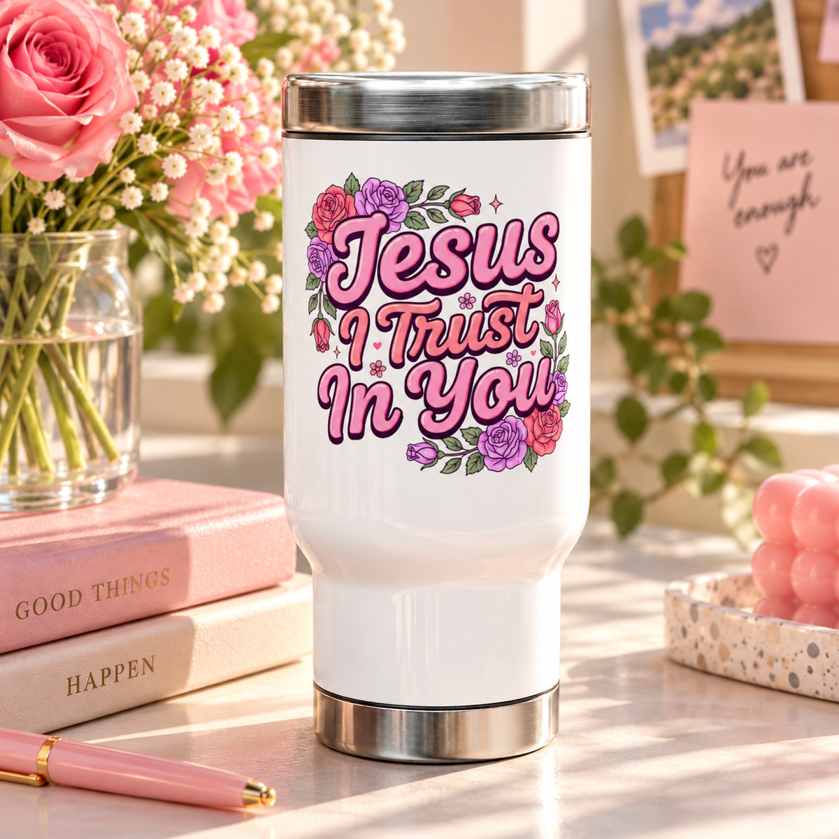 A white stainless steel travel mug with a silver lid and base, printed with "Jesus I Trust In You" in pink retro script framed by pink, red and purple roses and greenery.