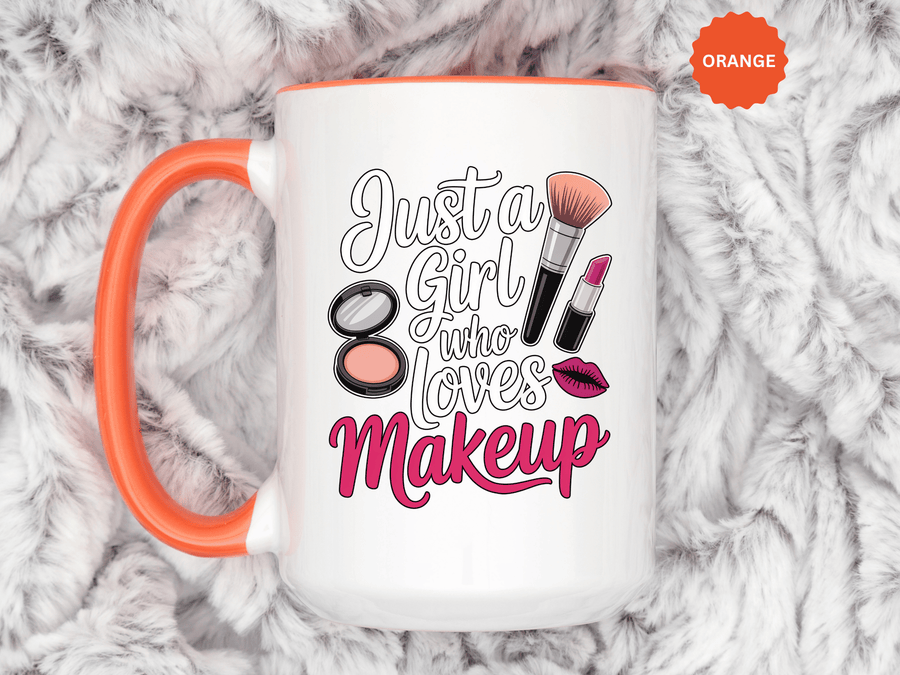 A white ceramic mug with a colored handle and interior, printed with "Just a Girl who Loves Makeup" in white and magenta script with a makeup brush, lipstick, a compact and pink lips.