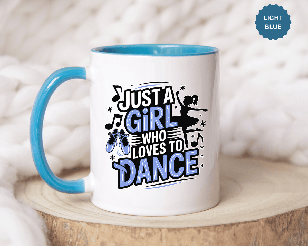 A white ceramic mug with a colored handle and interior, printed with "JUST A GIRL WHO LOVES TO DANCE" in black and blue lettering with blue ballet shoes, music notes and a ballerina silhouette.