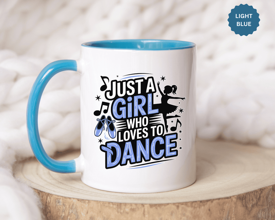 A white ceramic mug with a colored handle and interior, printed with "JUST A GIRL WHO LOVES TO DANCE" in black and blue lettering with blue ballet shoes, music notes and a ballerina silhouette.