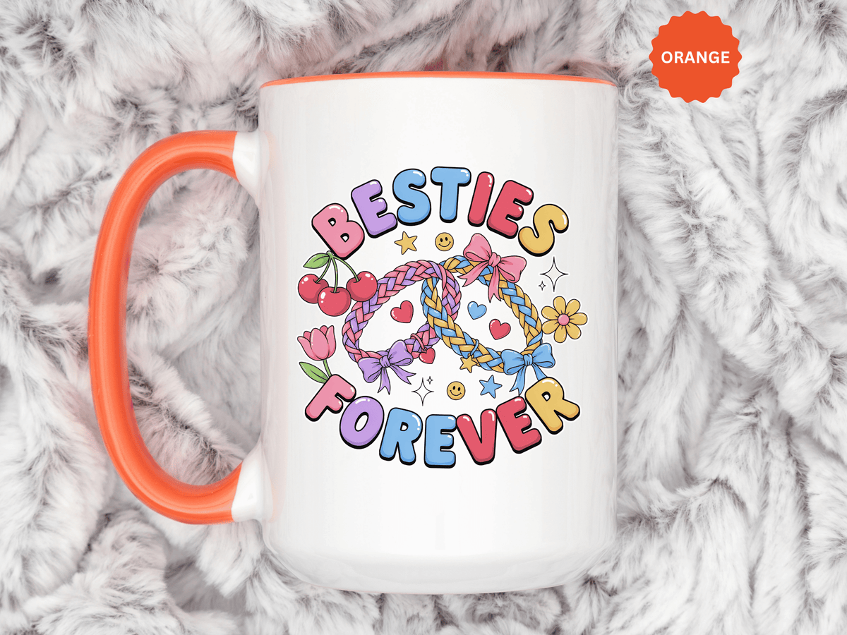 A white ceramic mug with a colored handle and interior, printed with "BESTIES FOREVER" in pink, blue, purple and yellow bubble letters around two braided friendship bracelets with bows, cherries, a tulip, a daisy and hearts.