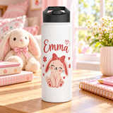 A white stainless steel water bottle with a black flip-top lid, printed with the sample name "Emma" in red script above a smiling pink bunny with a red bow, surrounded by small red hearts and flowers.