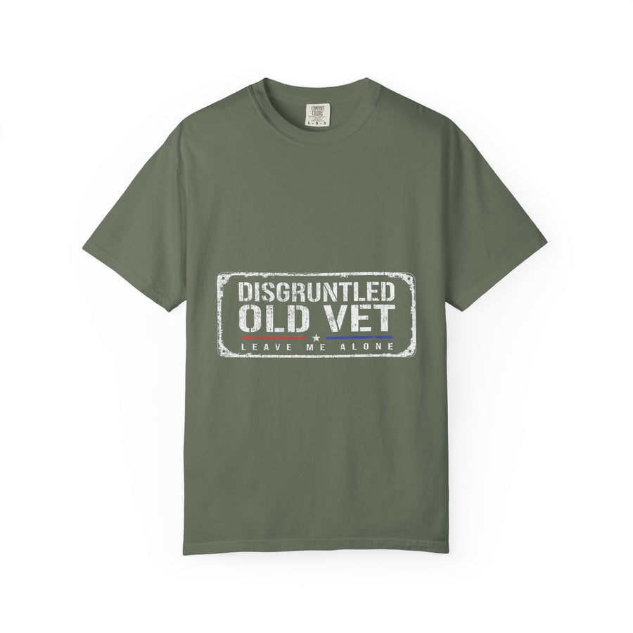 A woman wearing a green T-shirt printed with a distressed rectangular badge reading Disgruntled Old Vet and Leave Me Alone.