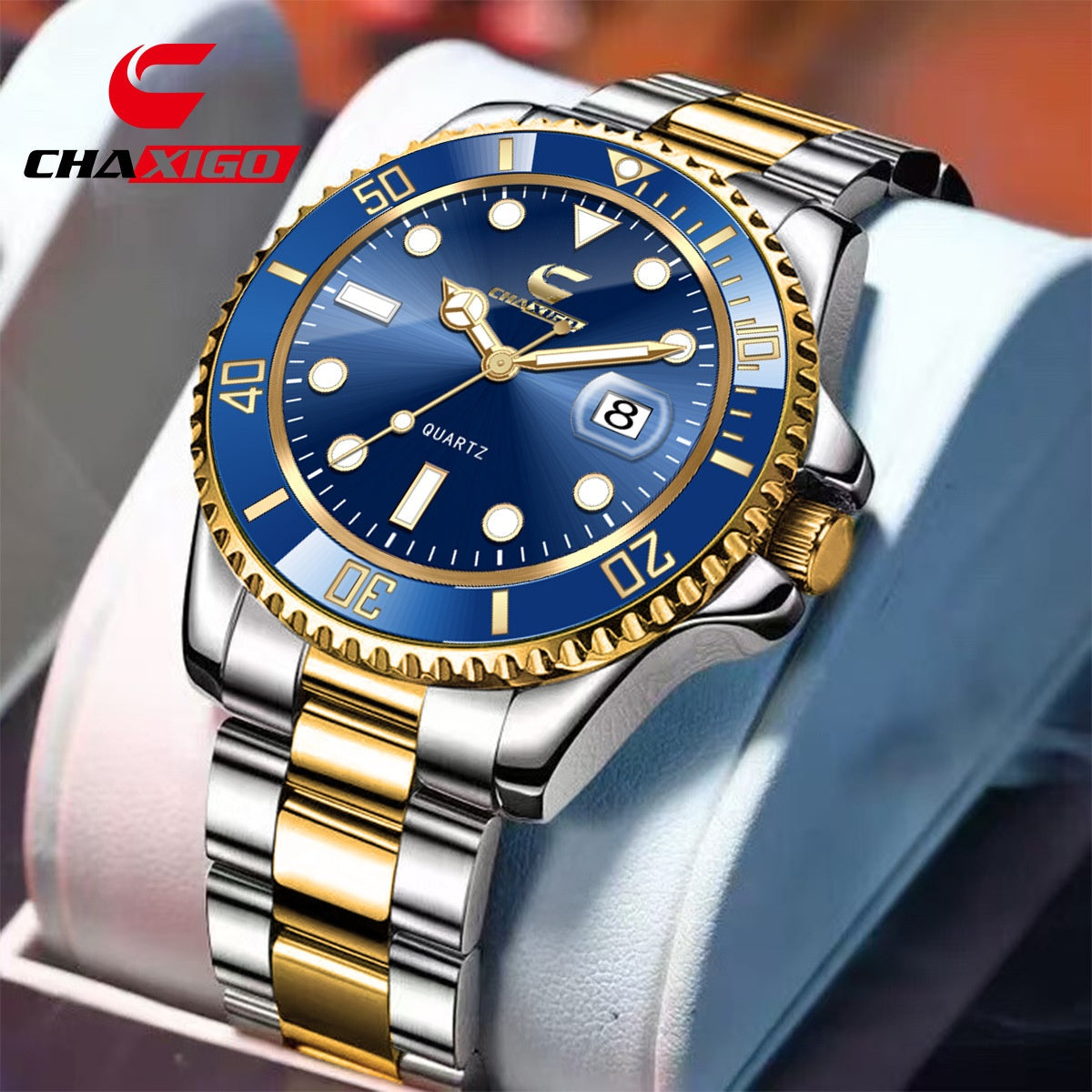 Two-tone gold and silver quartz watch with a blue diver style dial, bezel, and date window