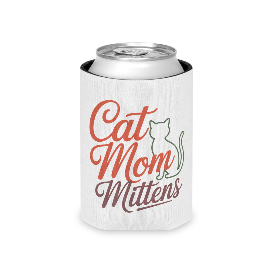 A white foam can cooler printed with a Cat Mom Mittens design in red, green, and brown, holding a beverage can, styled on a table with books and a cat figurine.