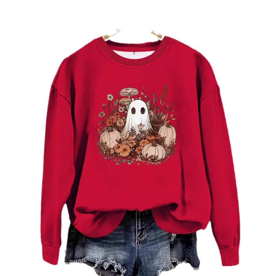 A red crewneck sweatshirt printed with a small ghost among pumpkins, mushrooms and autumn flowers.