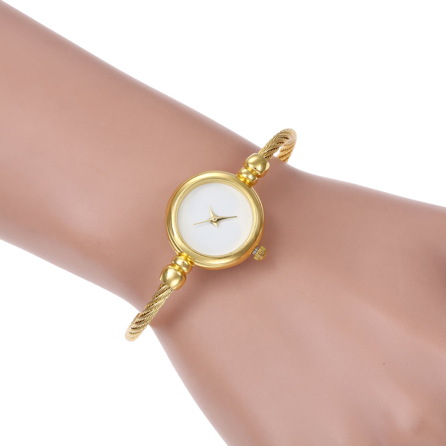 Gold-tone twisted wire bracelet watch with a round white dial, shown worn on a wrist