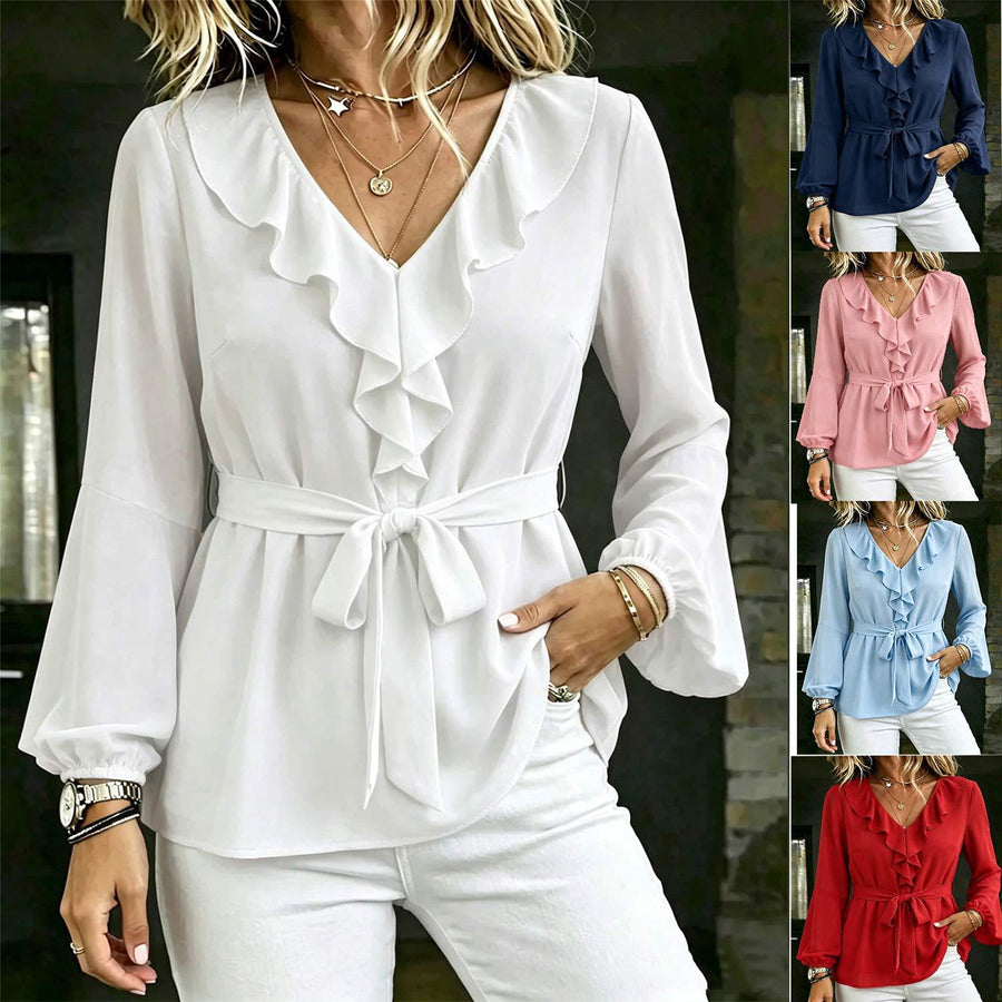 The same blouse shown in five colourways, white, navy, pink, pale blue and red, each with a cascading ruffle down the V neckline and a self tie knotted at the waist, each worn with plain white trousers.