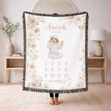 Fringed woven milestone blanket bordered with blush and cream watercolour roses and eucalyptus, printed with the name Amarah Elise and the numbers 1 to 12 beneath the word months.