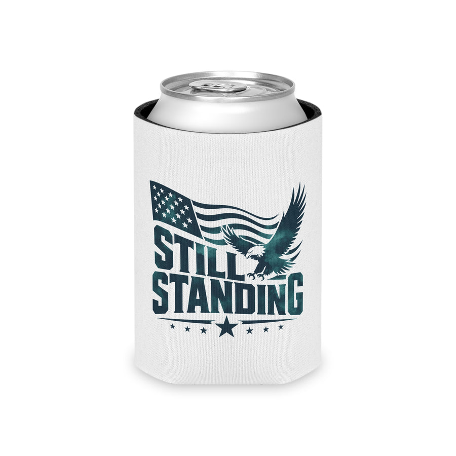 A white can cooler on a drink can, printed with "STILL STANDING" in dark green lettering with a soaring bald eagle, a waving American flag and stars.