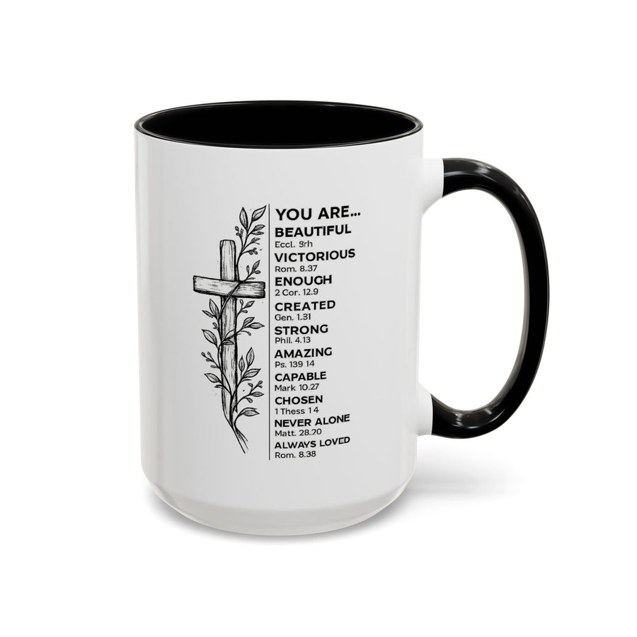 White mug printed with a line drawn wooden cross wrapped in a leafy vine, beside a list headed You Are reading Beautiful, Victorious, Enough, Created, Strong, Amazing and more.