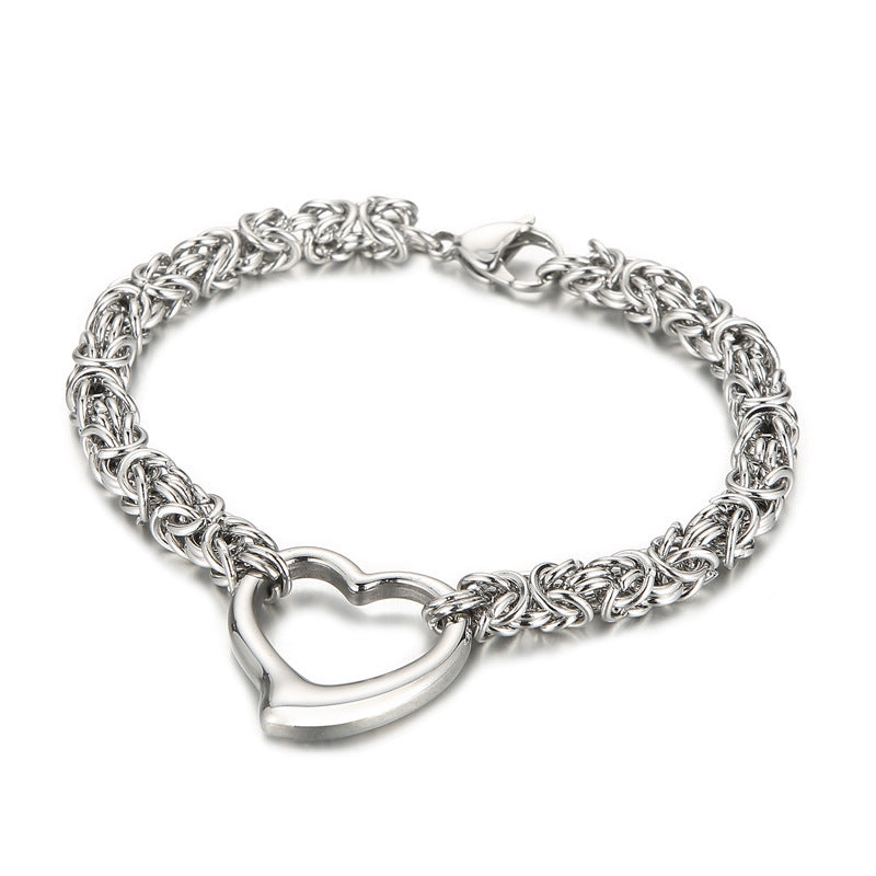 Silver stainless steel chain bracelet with an open heart charm, on white background