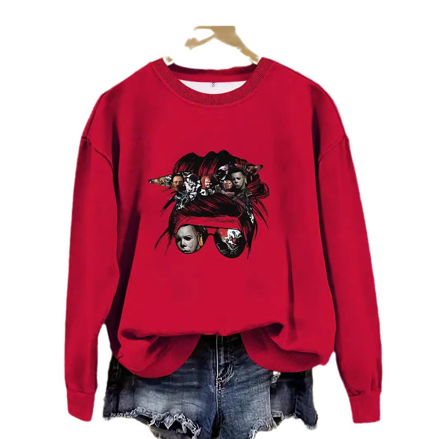 A red crewneck sweatshirt printed with a messy bun and sunglasses design made of horror-movie character faces.
