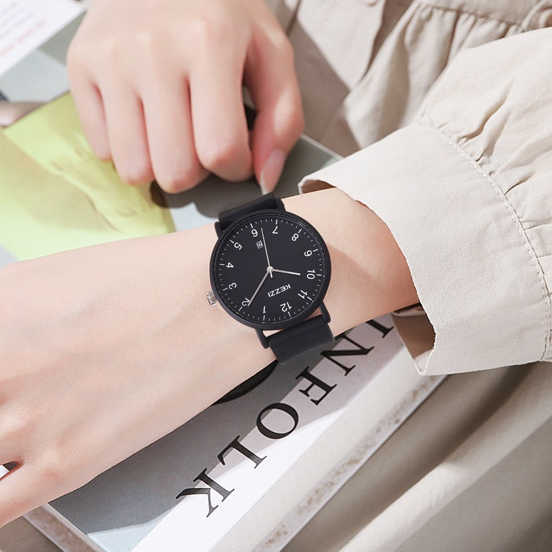 All-black minimalist watch with a round dial, shown worn on a wrist