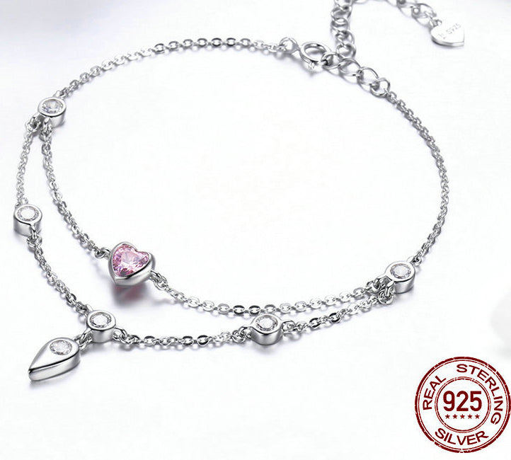 Sterling silver double chain bracelet with a pink heart charm and clear crystal stations