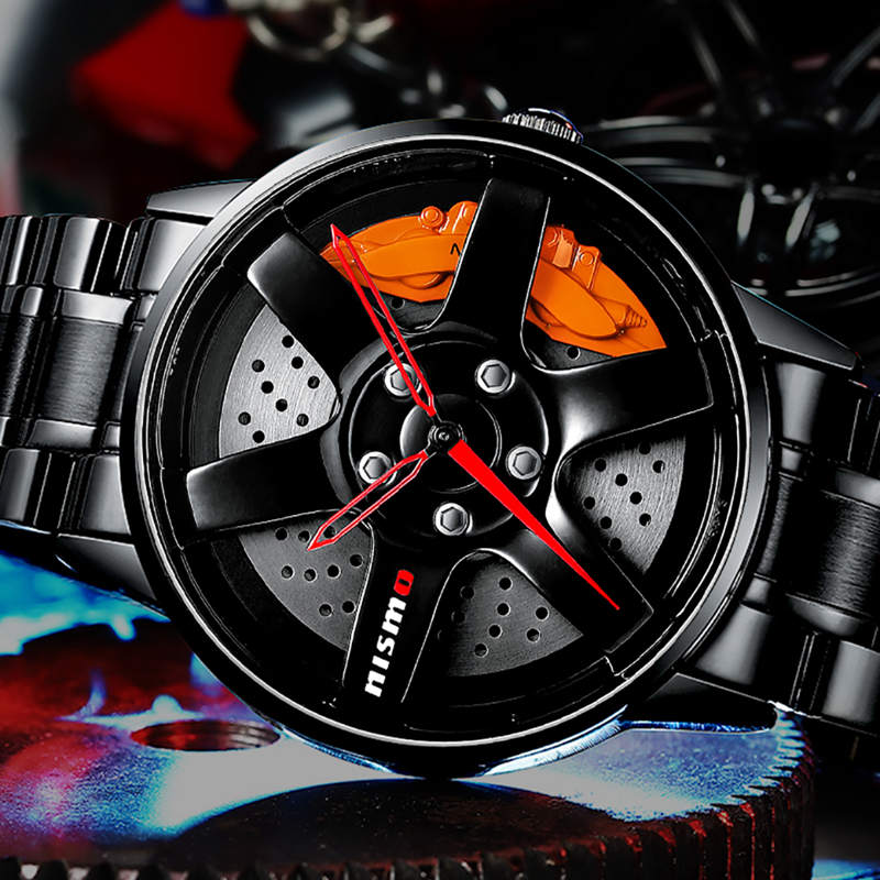 Wheel-rim style watch with a black metal band, worn on wrist with a suit and tie