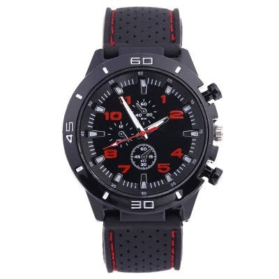 Black watch with red accents, chronograph-style dial and a perforated black silicone strap with red stripe