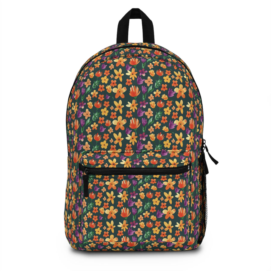 A backpack with black top handle, front zip pocket and mesh side pocket, covered in an all-over print of orange, yellow and purple wildflowers on a dark green background.