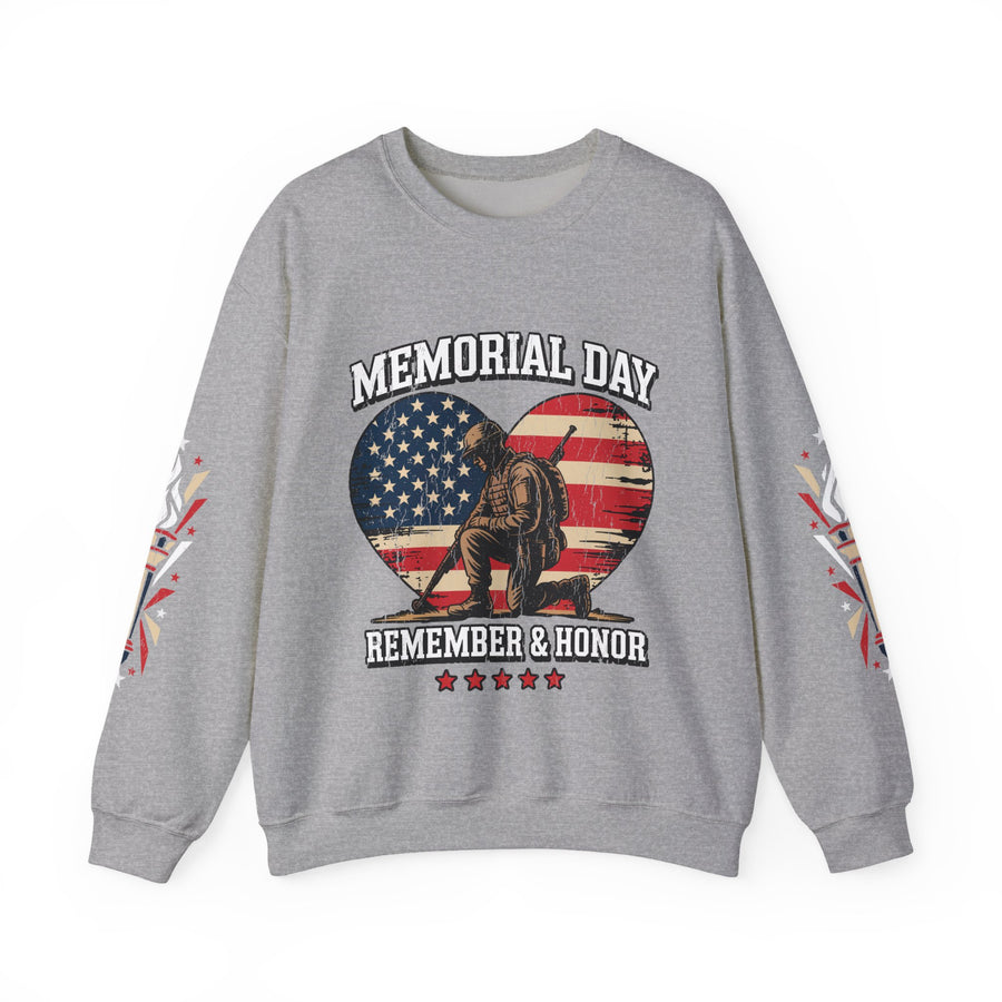 A woman wearing a gray crewneck sweatshirt printed with Memorial Day above a kneeling soldier inside an American flag heart and Remember & Honor, with torch graphics on both sleeves.