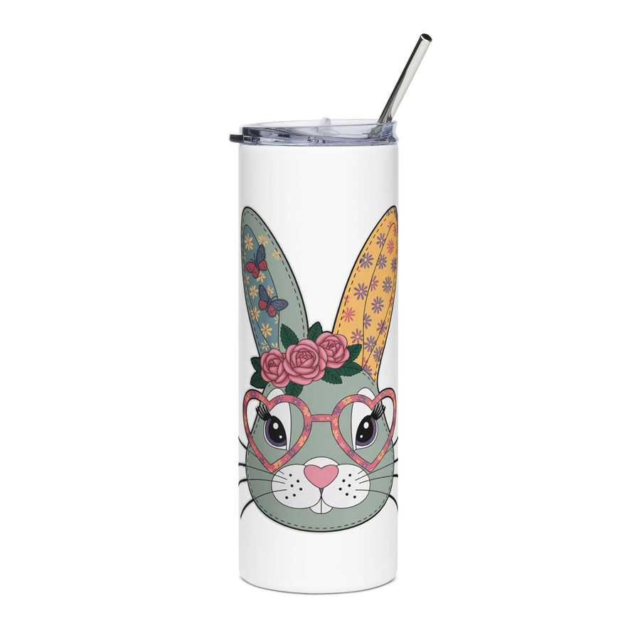 A white stainless steel skinny tumbler with a clear lid and metal straw, printed with a cute gray-green bunny face wearing pink heart-shaped glasses and a crown of pink roses, with butterfly and flower patterned ears.