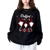 A black crewneck sweatshirt printed with three gnomes in red plaid hats and the words Chillin' with my Gnomies.