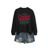 A black crewneck sweatshirt printed with Christmas Baking Crew in red and green lettering with holly.