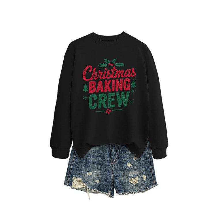 A black crewneck sweatshirt printed with Christmas Baking Crew in red and green lettering with holly.