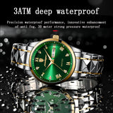 Green sunburst dial watch with gold accents and a two-tone silver and gold bracelet, shown with water droplets