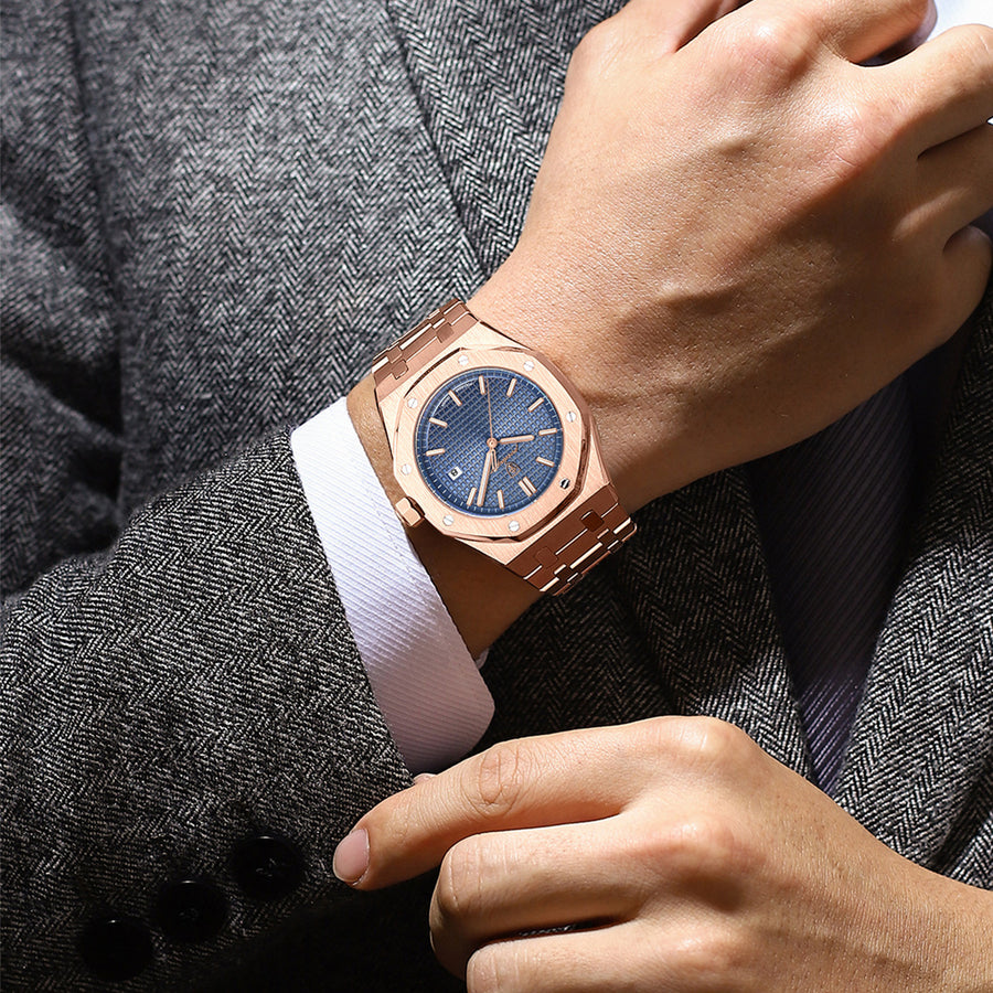 Rose gold-tone watch with a blue textured dial, octagonal bezel, shown with water droplets on the case