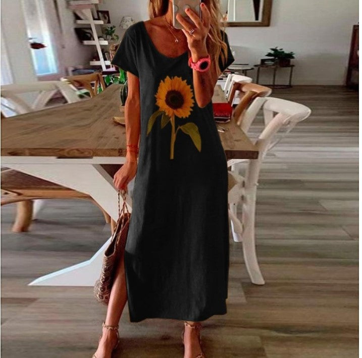The same maxi dress shown in six colourways, white, black, blue, yellow and pink, each printed with one large sunflower and cut with a long slit at the side seam, each worn with a woven straw bag.