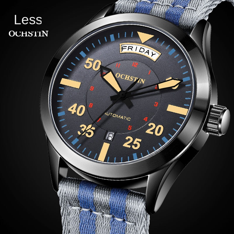 Black pilot style automatic watch with day and date windows and a striped nylon strap