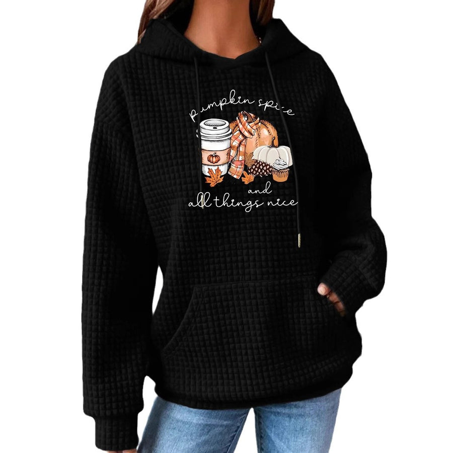 A black waffle-knit hoodie with a kangaroo pocket printed with a pumpkin spice latte, pumpkins and cozy fall items under pumpkin spice and all things nice.