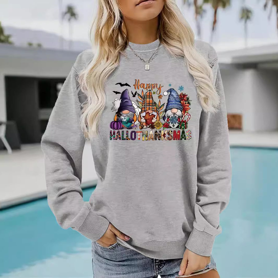 A red crewneck sweatshirt printed with three gnomes among pumpkins, bats and holiday decor above the words Happy Hallothanksmas.