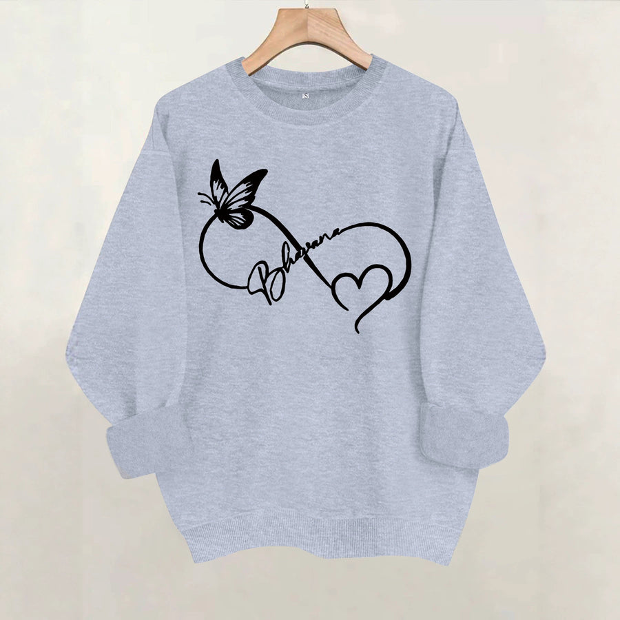 A brown crewneck sweatshirt printed with a black line-art infinity symbol with a butterfly, a heart and script lettering.