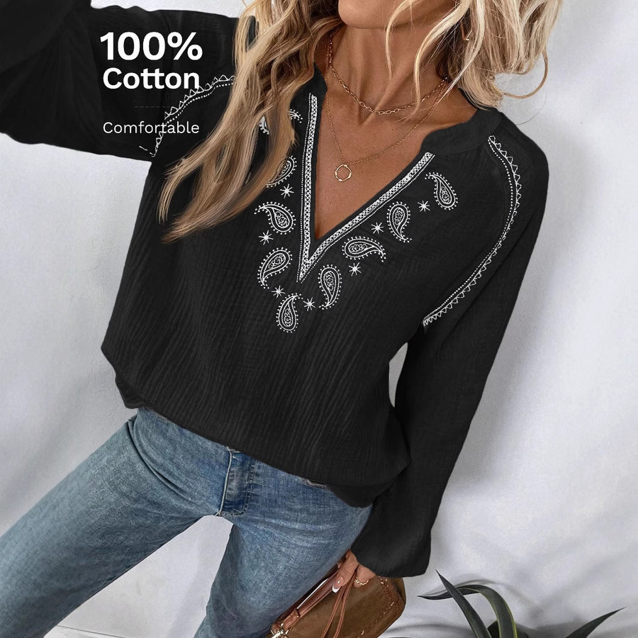 The same crinkle cotton blouse shown in four colourways, white, navy, black and sage green, each embroidered at the V neckline and shoulders with a blue paisley motif, each shown worn with blue jeans.