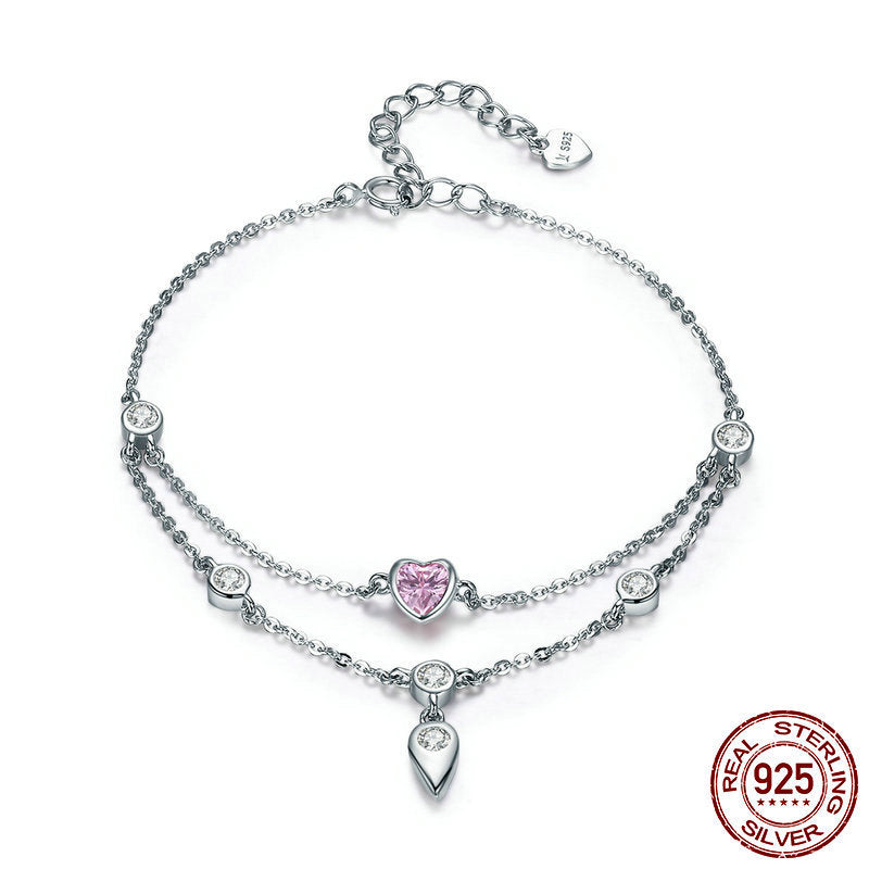 Sterling silver double chain bracelet with a pink heart charm and clear crystal stations