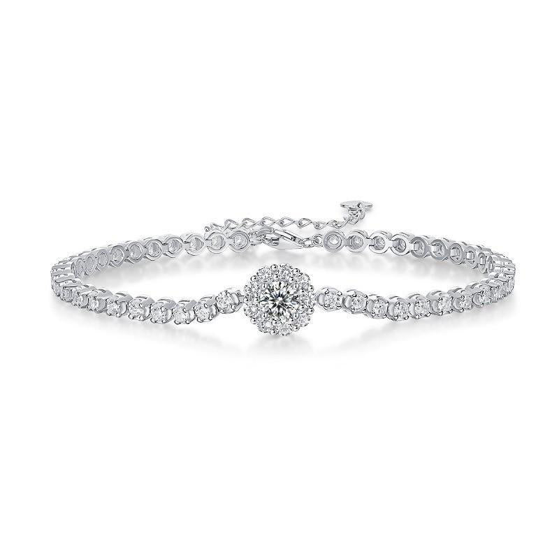 Silver tennis bracelet with a round crystal cluster centerpiece, on white background