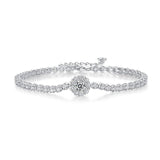 Silver tennis bracelet with a round crystal cluster centerpiece, on white background